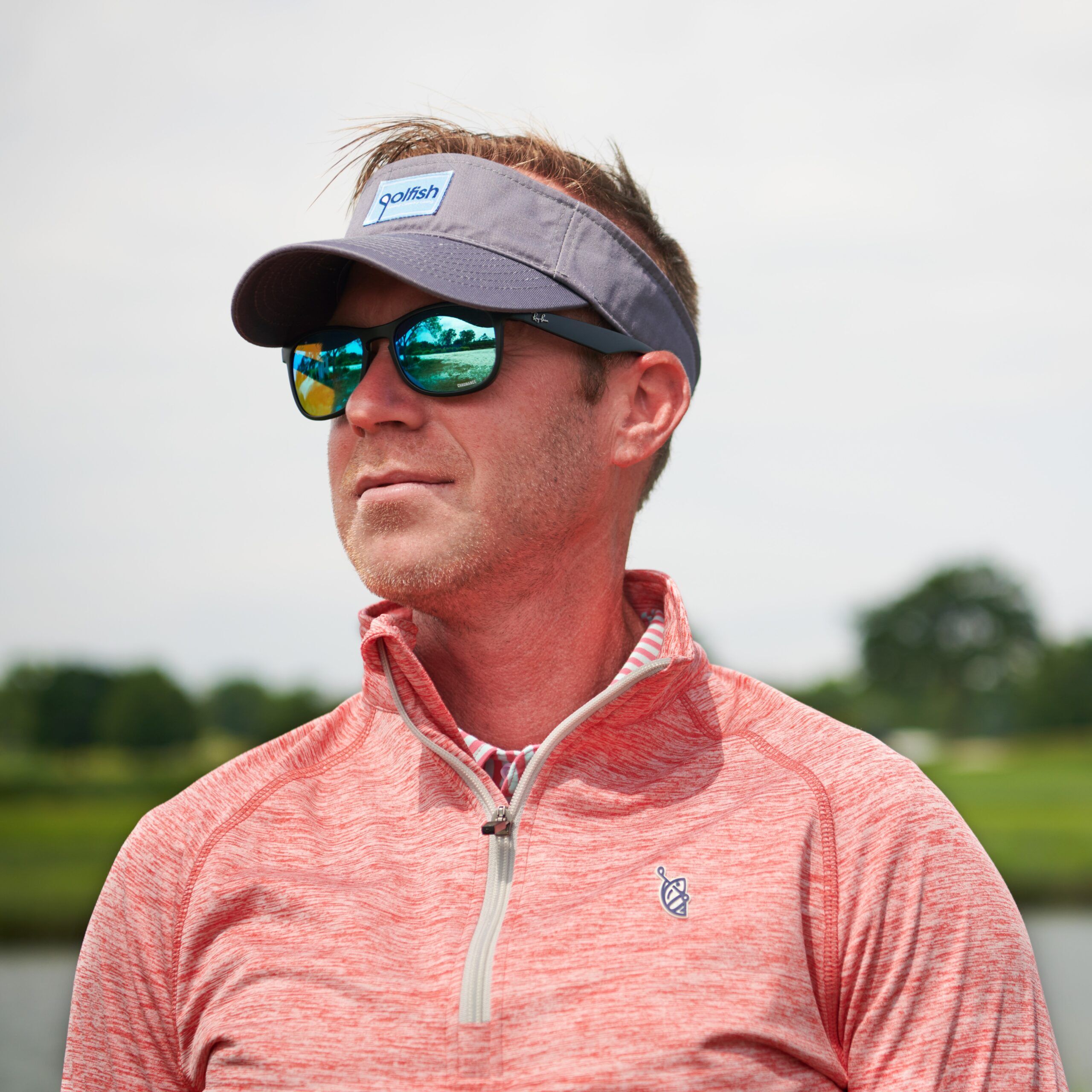 man on the golf course wearing a quarter zip pullover